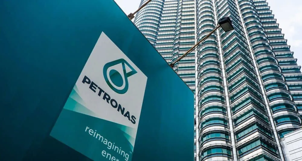 Petronas logo in front of skyscraper building