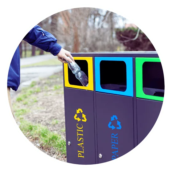 Recycling plastic bottle into bin outdoors.