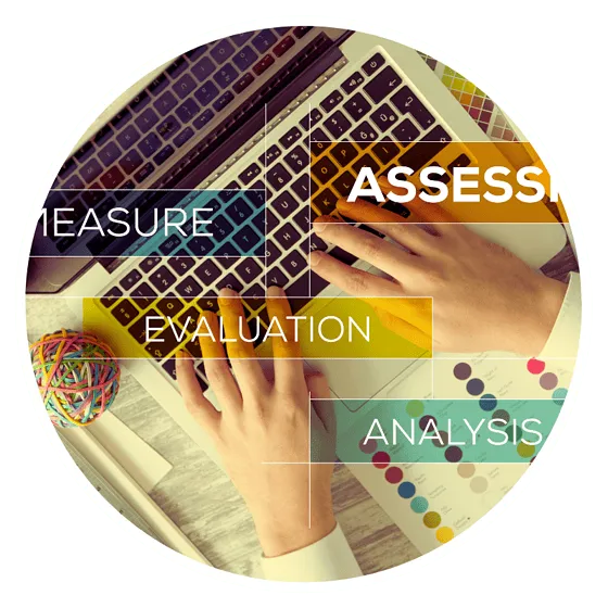 Hands typing on laptop with analysis keywords.
