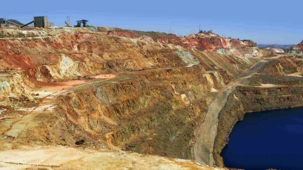 Large open-pit mine with exposed earth layers.