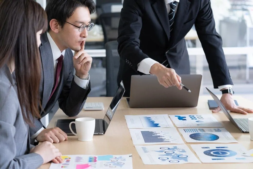 Business meeting with charts and laptops on table
