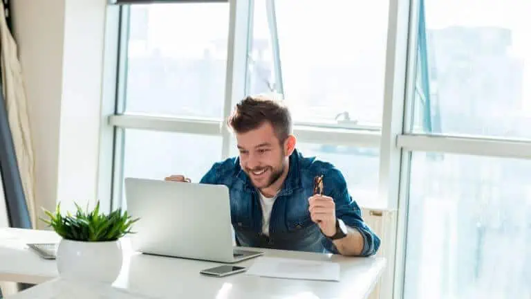 Happy man celebrating success on laptop