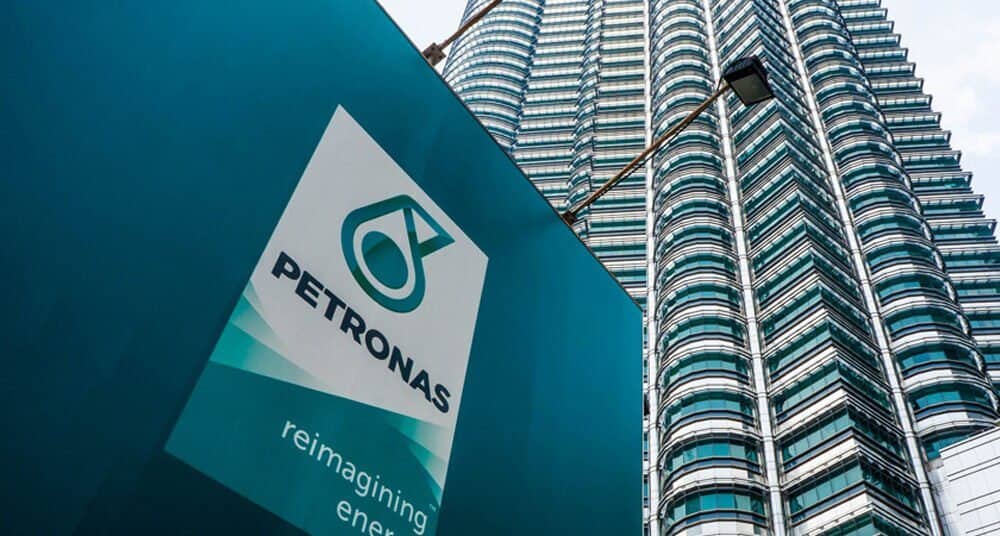 Petronas logo in front of skyscraper building