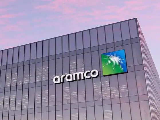 Aramco building with glass facade at sunset.