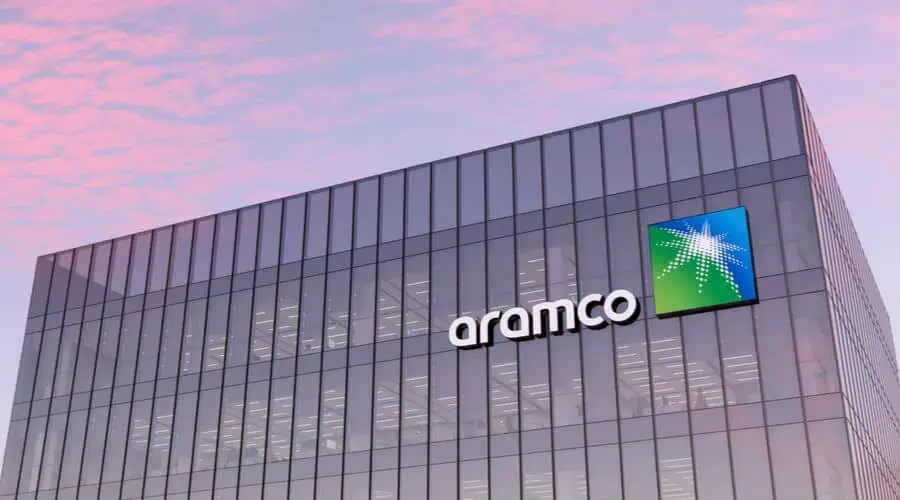 Aramco building with glass facade at sunset.