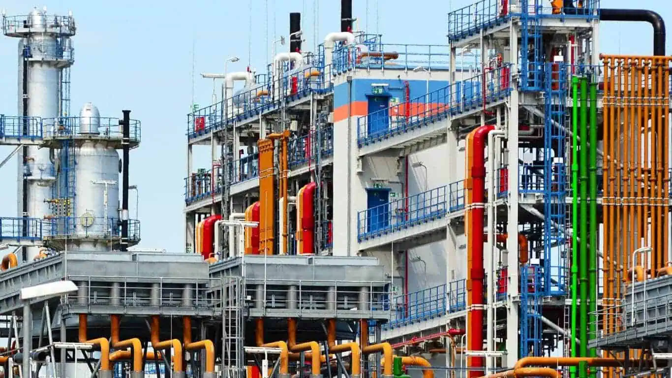 Colorful industrial factory with pipes and structures.