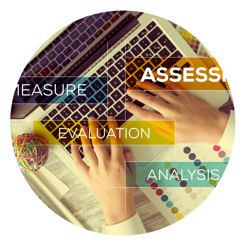 Hands typing on laptop with analysis keywords.